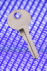 Key isolated on programm code background. Programming, safity, networs.