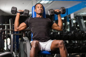 Black African American  young man doing  workout at the gym