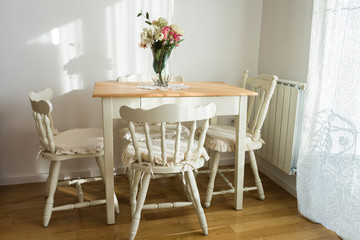 Nicely decorated living ( lunch ) room. Dining table and some chairs.