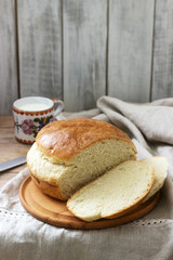 Fresh homemade wheat yeast bread on a linen tablecloth. Rustic style.
