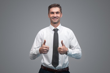 Adult businessman gesturing thumb ups