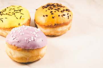 Donuts. Assorted donuts lying on a white table, copy space. Selective focus. Сoncept sweet food.