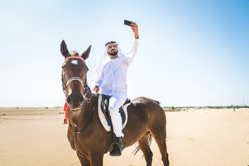 Arabian man with horse in the desert