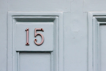 House door number fifteen with the 15 in silvery metal digits