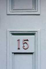 House door number fifteen with the 15 in silvery metal digits