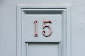 House door number fifteen with the 15 in silvery metal digits