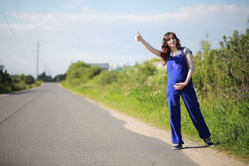 Pregnant woman on the road stops the car