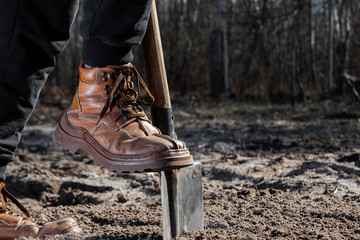 Boots and shovel closeup. The concept of the garden, the beginning of the season, summer cottage.