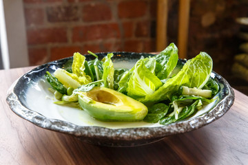 Green Salad with avocado and lettuce is on the plate