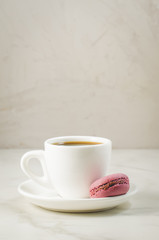 sweet macaroons or macaron and coffee cup on a white background, selective focus. French dessert