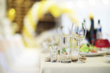 Glasses on the table in the restaurant. Table setting.