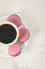 sweet macaroons or macaron and coffee cup on a white background, top view. French dessert