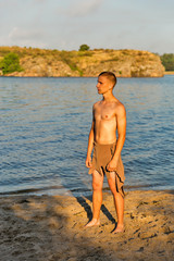 Fototapeta na wymiar guy in loincloth on the background of river beach