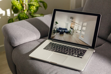 choosing hotel online, using travel application or booking service on laptop to find best place to stay on business trip, checking room reservation availability on website, close up rear view