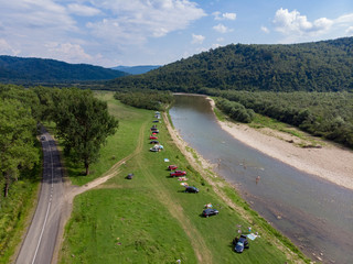 camping tent with car near mountains river