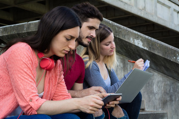 Group of  University students studying together outdoors
