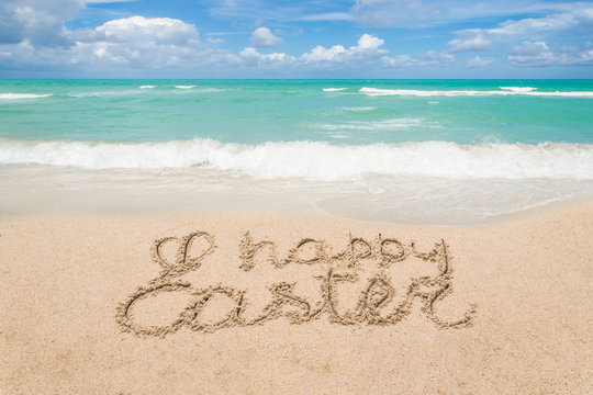 Happy easter lettering background on the sandy beach