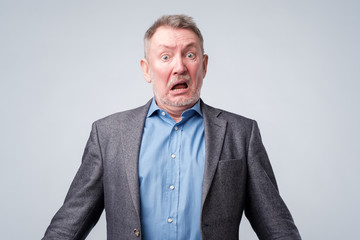 Shocked and wow face of senior european man