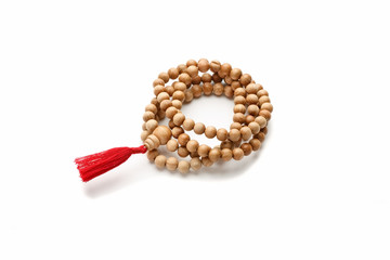 Obraz premium Wooden buddhist rosary with red tassel isolated on white