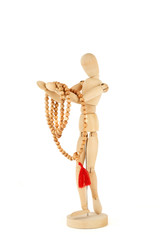 Wooden dummy holding rosary isolated on white