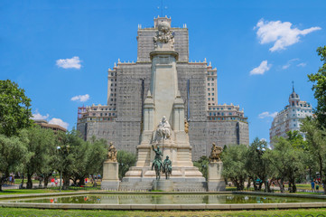 Obraz premium Monumento Cervantes upfront. Behind is the Edificio España under reparations. Shoot in July 2018