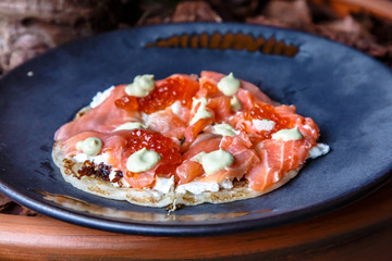 Roti Paratha stuffed with salted salmon and red caviar with cream.
