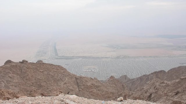 A Panorama of Al Ain, United Arab Emirates View on a hot day from Jebal Hafeet (Jebel Hafit) showing the city from the top of the mountain.