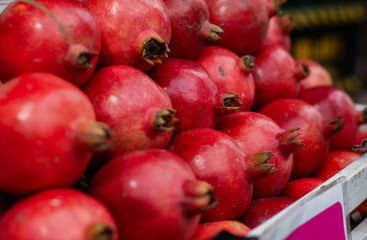 Pile of red ripe organic pomegranates,