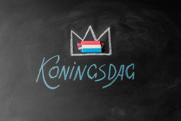 Fototapeta na wymiar Holland traditional festival Koningsdag Kings day on chalkboard