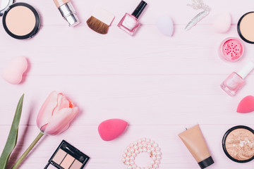 Obraz na płótnie Canvas Feminine makeup products on pink table