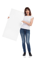 Young Woman Is Holding White Poster, Pointing And Talking