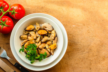 mussels A serving of seafood is a white plate. food background. top image