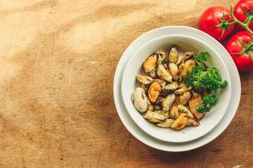 mussels A serving of seafood is a white plate. food background. top image