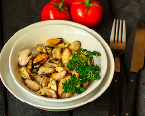 mussels A serving of seafood is a white plate. food background. top image