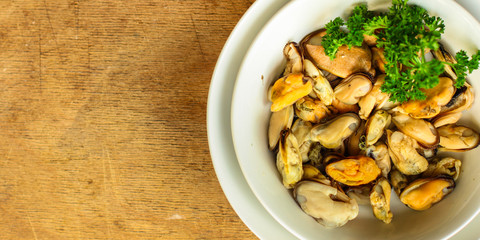 mussels A serving of seafood is a white plate. food background. top image