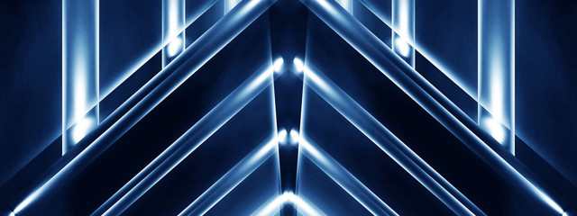 Abstract blue background with lines and rays of neon light. Reflection in space of symmetry. Abstract tunnel in motion.