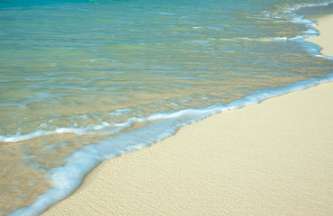 Fototapeta na wymiar Soft wave of blue ocean on sandy beach.