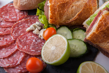 cold meat dish and sandwiches