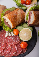 cold meat dish and sandwiches