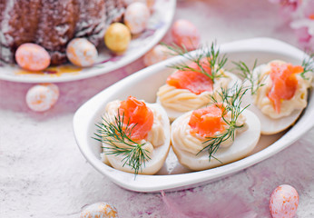 Easter breakfast.Cake and eggs with salmon