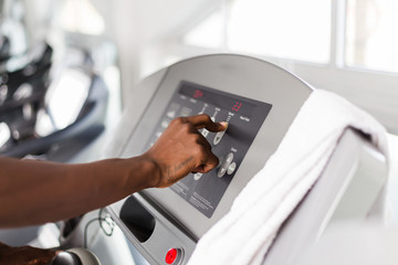 Black African American  young man doing cardio workout at the gym