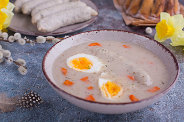 Easter breakfast. Sour rye soup with eggs and sausage