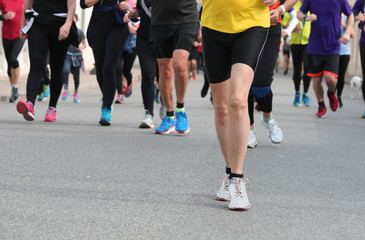 many legs of runners on the road