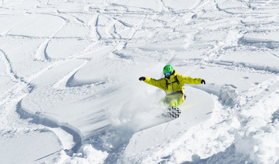 Young man flying on snowboard on powder day at white snowy background