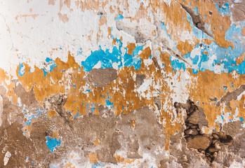  wall of plaster white yellow blue peeling paint.