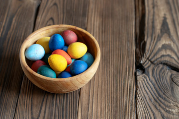 Fototapeta na wymiar Painted eggs in a wooden bowl