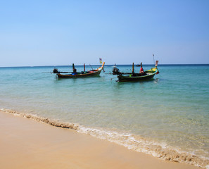 Fototapeta na wymiar February 11, 2019. Karon beach, Thailand. Fishing boats at sea, near the shore.