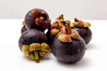 Tropical fruit mangosteen on a white table