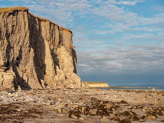 Silver strand cliff, Galway city, Ireland. Blue cloudy sky, cliff''s texture and falling stones...