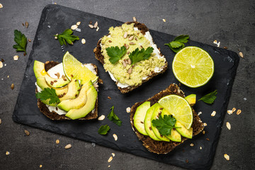 Sandwiches with avocado on black.